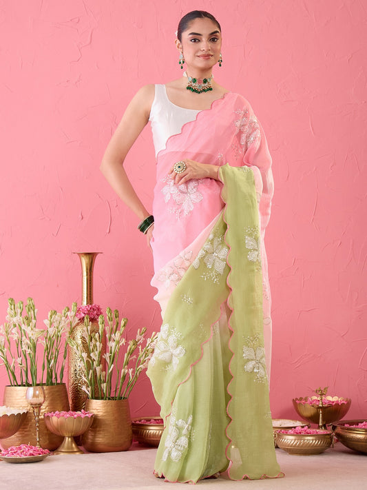Woman wearing pink chiffon ready to wear saree with ornamented surface design and white blouse