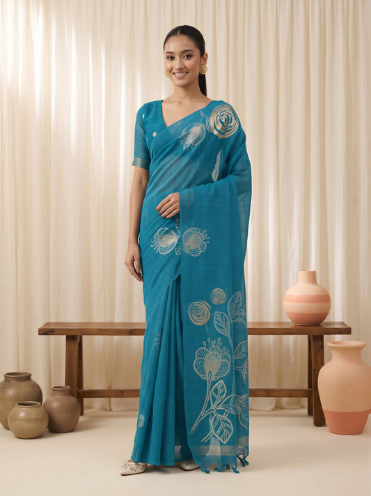 Woman wearing light blue pure silk saree with all-over floral design and light blue blouse