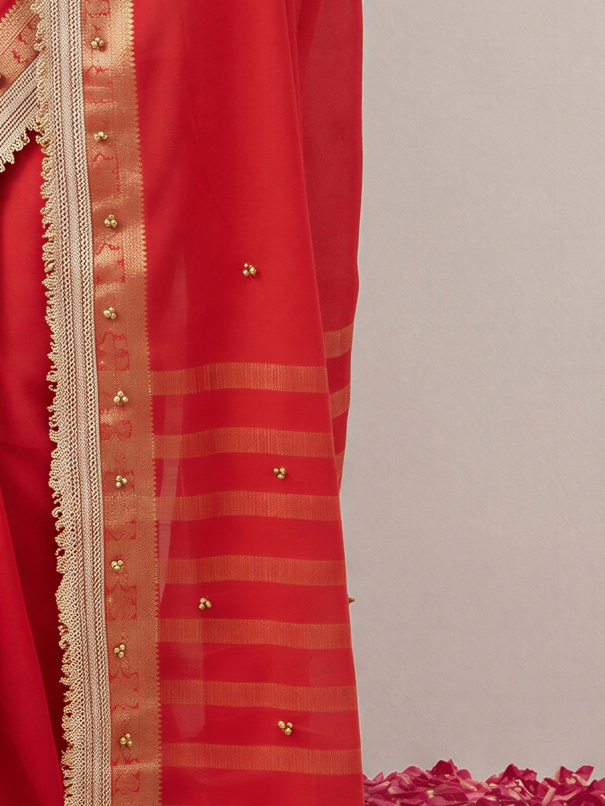 Pallu detail of red soft silk saree showing woven motif design and zari border
