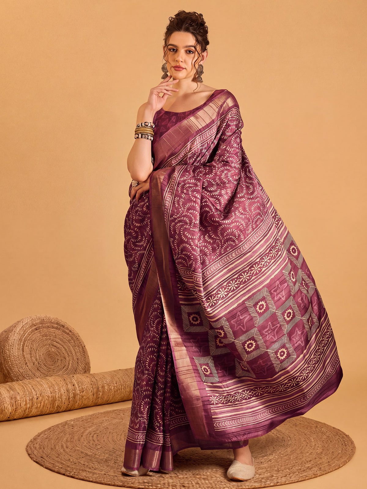 Woman wearing mauve silk blend saree with traditional indian motif work and mauve blouse