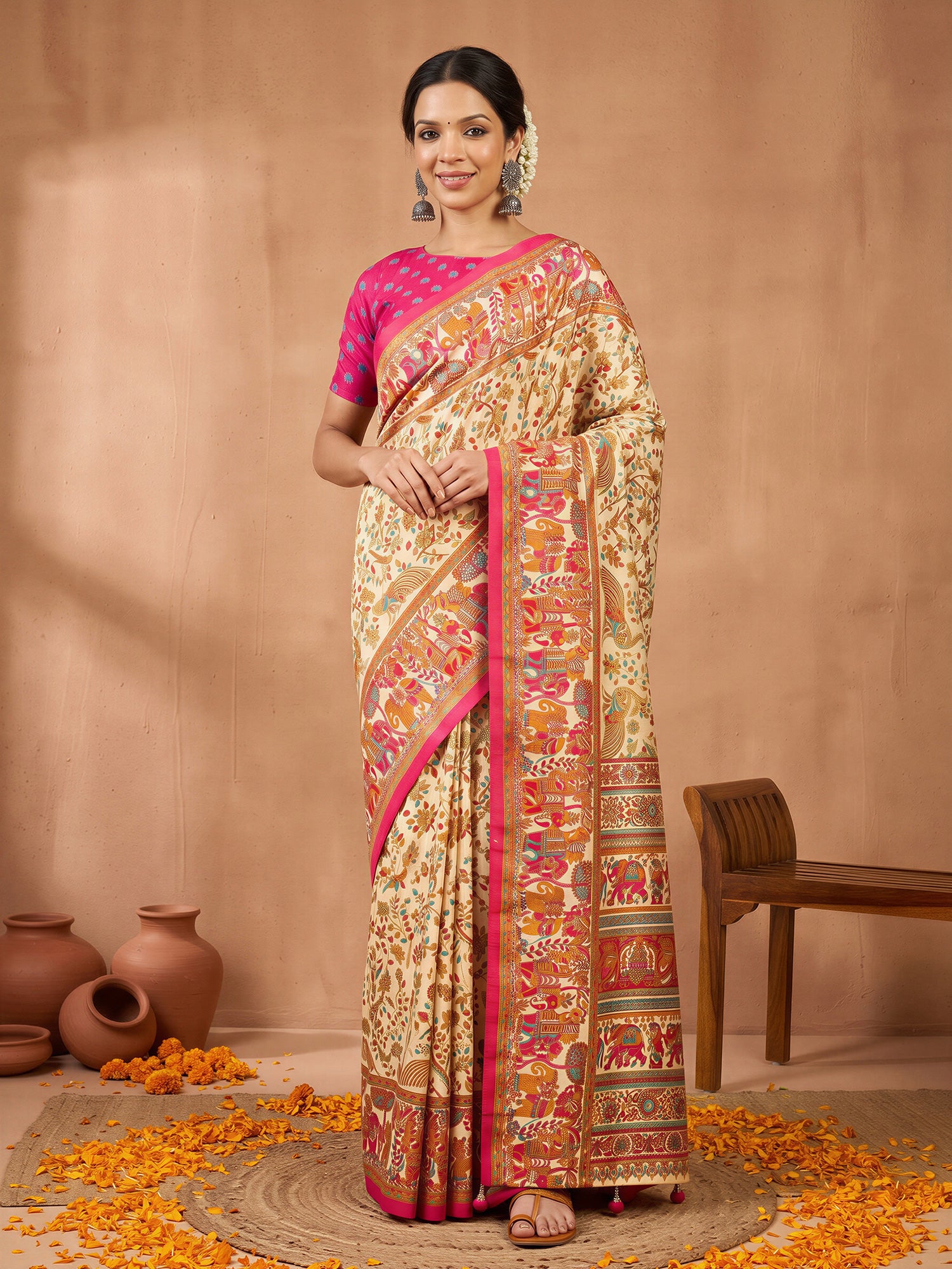 Woman wearing assorted silk blend saree with metallic foil print work and pink blouse