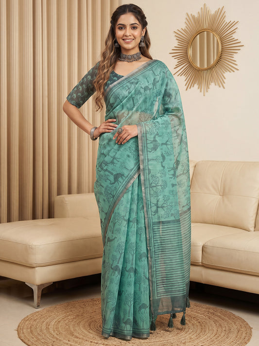 Woman wearing turquoise cotton linen saree with traditional indian motif work and teal green blouse