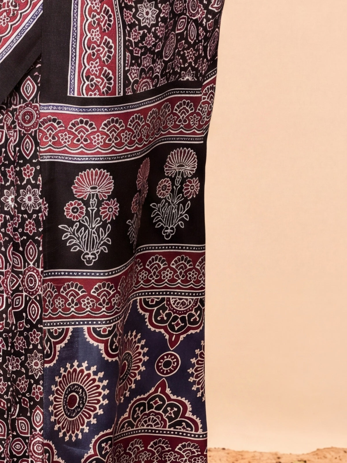 Pallu detail of black dola silk saree showing ajrak block-print motif work and solid border