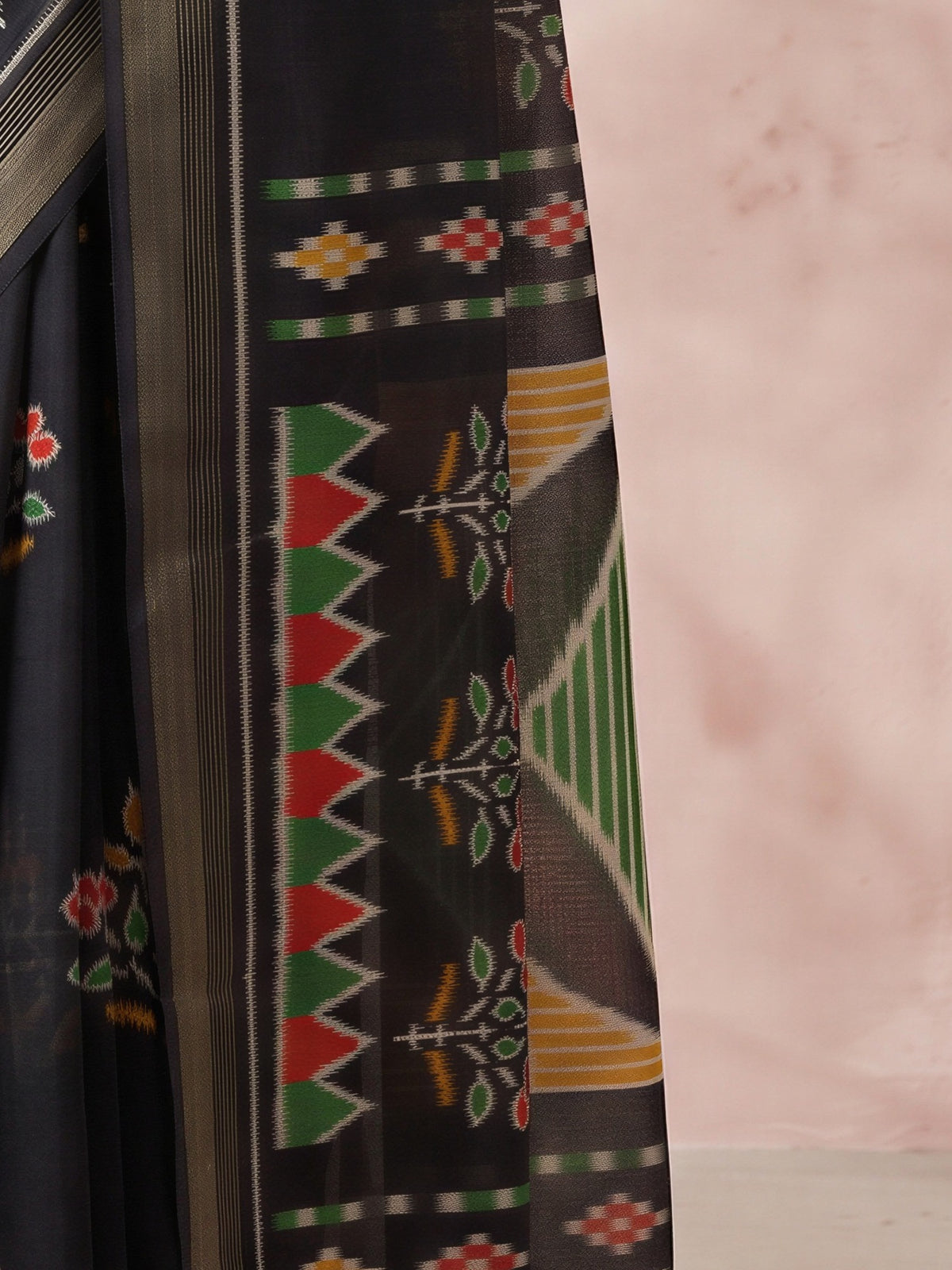 Pallu detail of black cotton linen saree showing traditional indian motif work and zari border