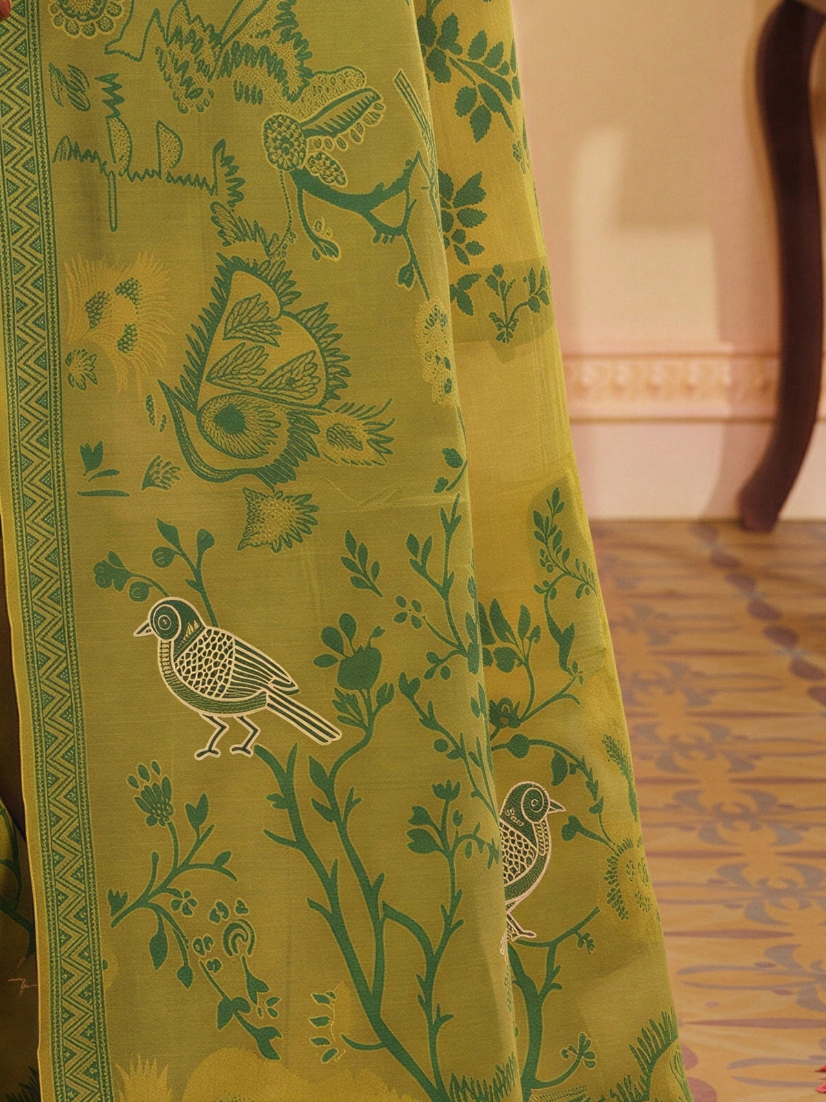 Pallu detail of olive silk blend saree showing traditional indian motif work and woven design border