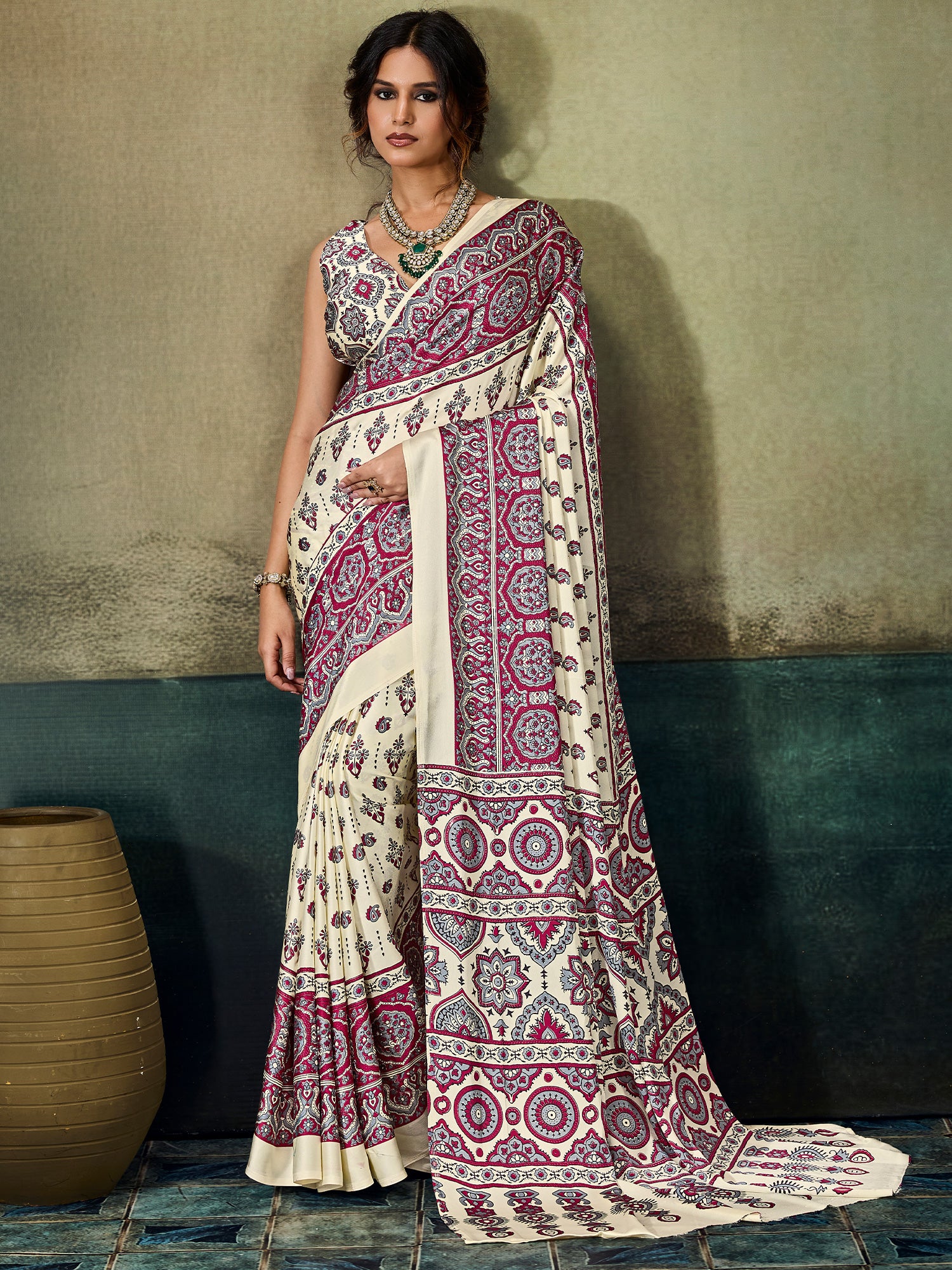 Woman wearing cream satin saree with ajrak block-print motif work and maroon blouse