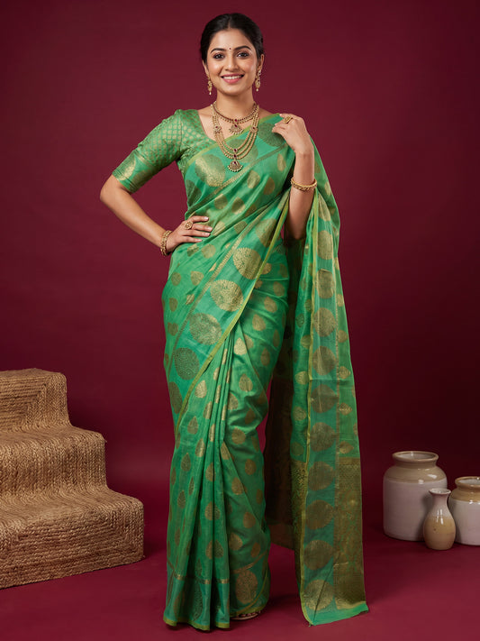 Woman wearing mint green silk blend saree with zari butta (metallic motif) work and mint green blouse