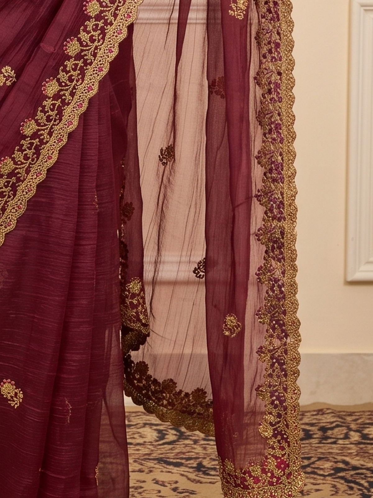 Pallu detail of mauve tissue saree showing ornamented surface design and zari border