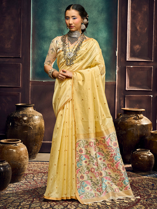 Woman wearing yellow cotton silk saree with zari butta (metallic motif) work and yellow blouse