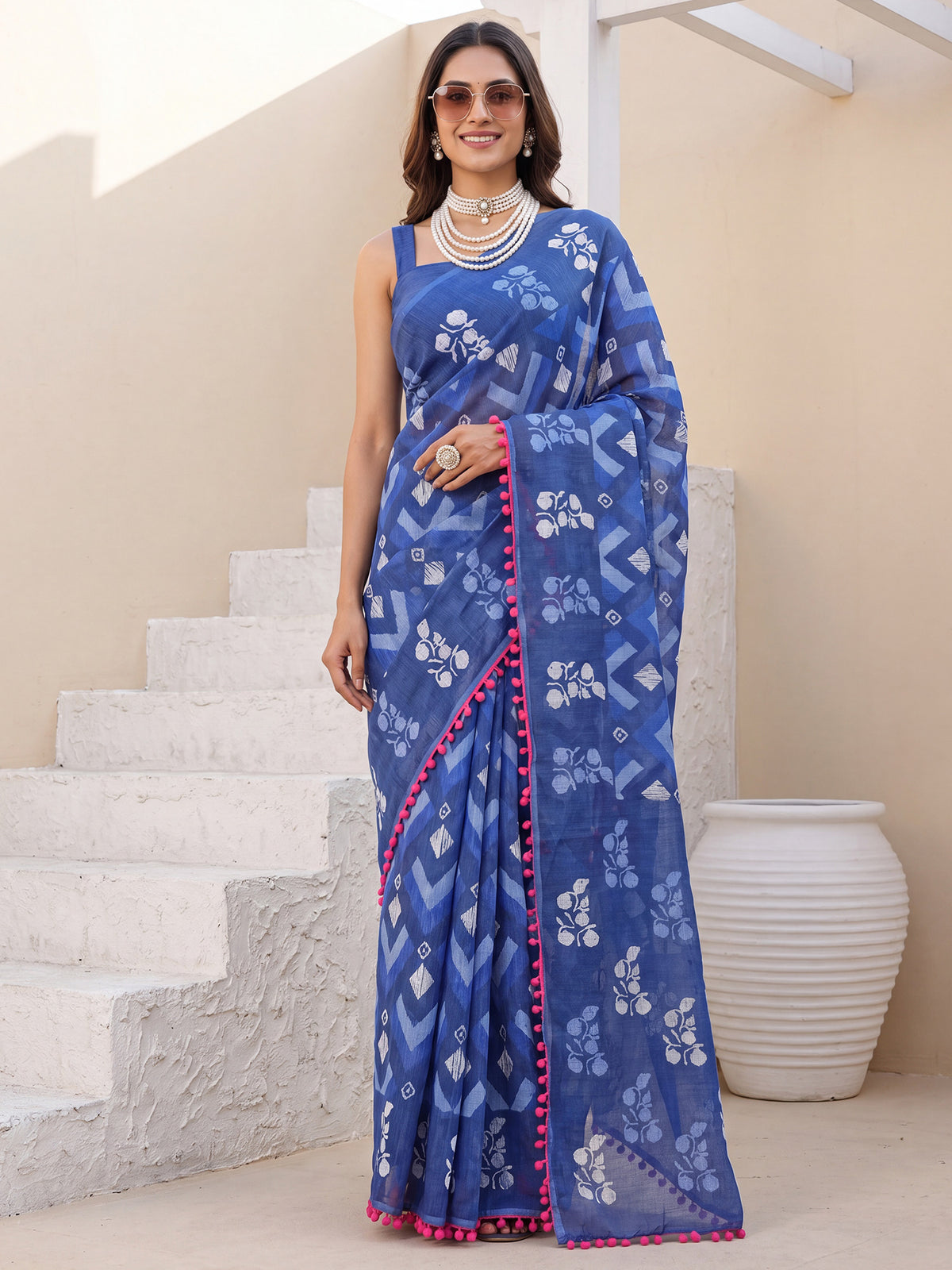 Woman wearing navy blue cotton saree with chevron zigzag pattern and navy blue blouse
