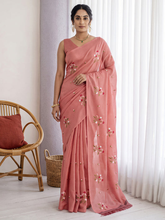 Woman wearing peach kota doria cotton saree with embroidered motif work and peach blouse