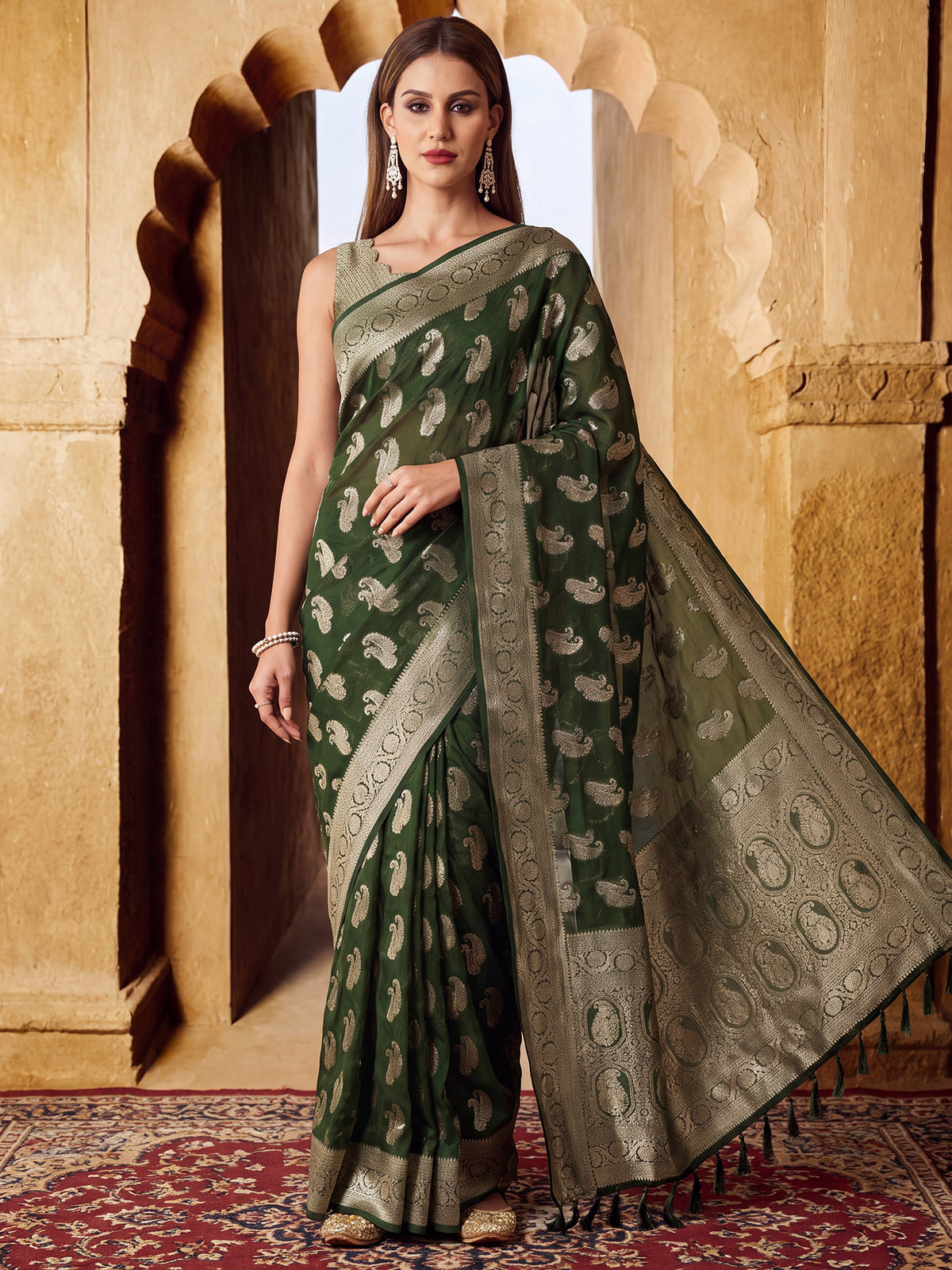Woman wearing green georgette saree with zari butta (metallic motif) work and green blouse