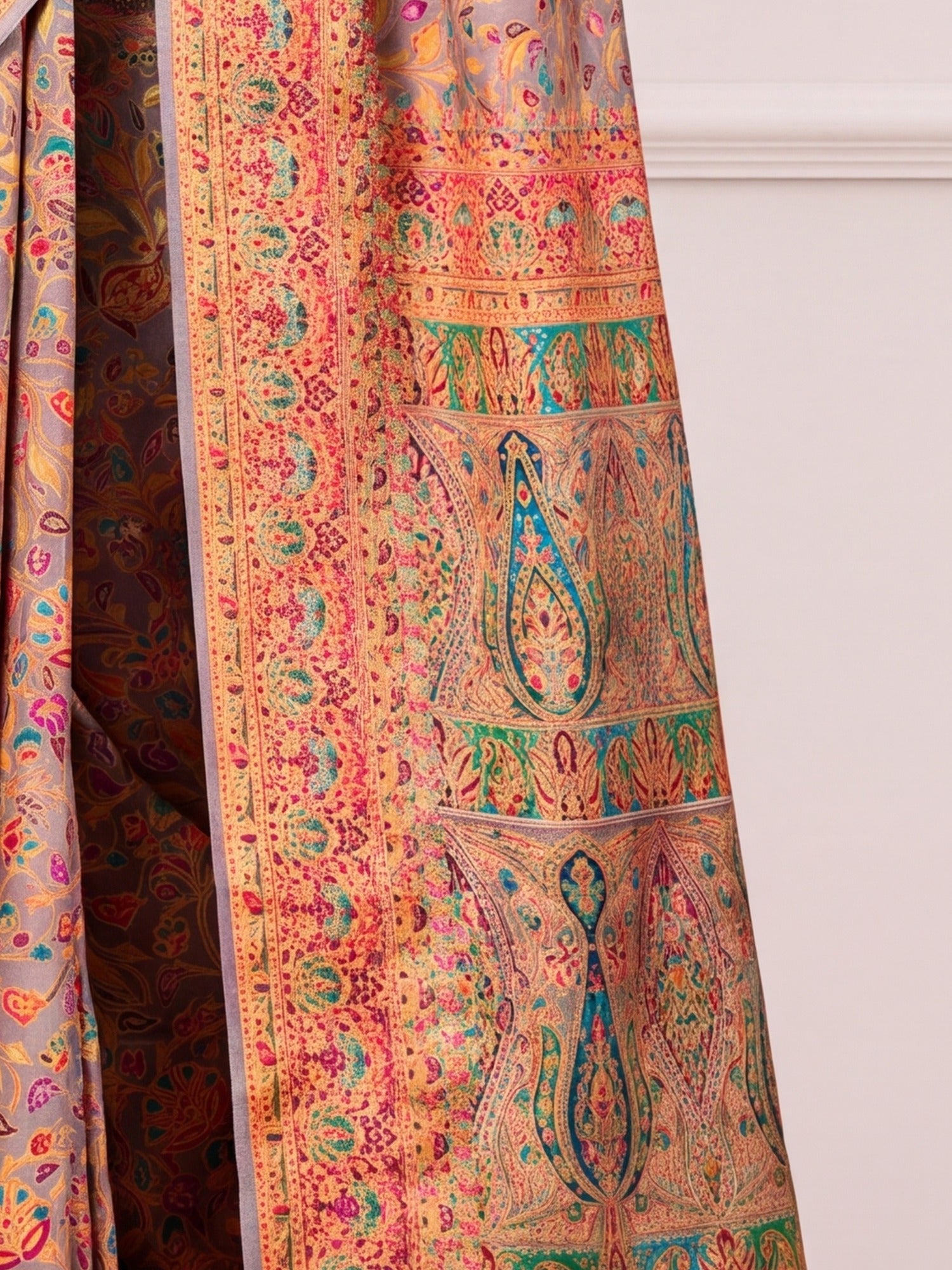 Pallu detail of light brown dola silk saree showing traditional indian motif work and zari border