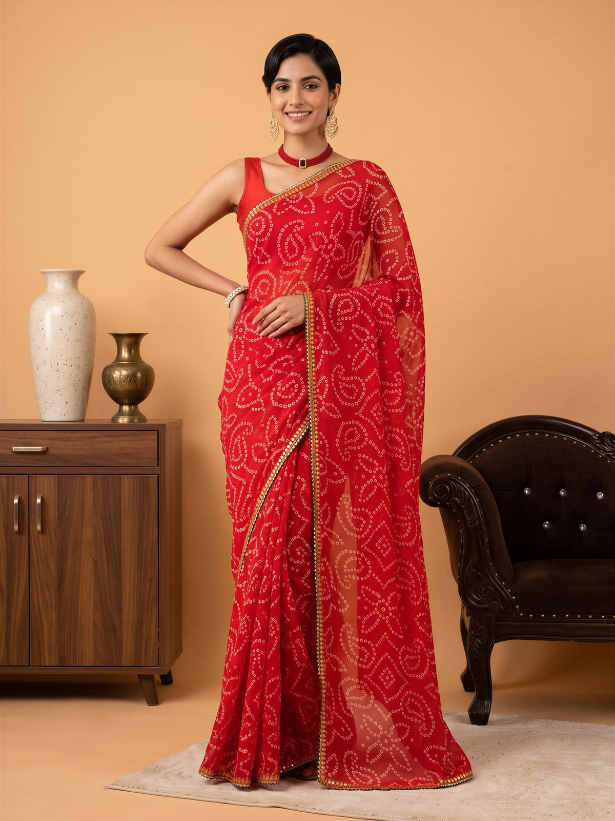Woman wearing red georgette saree with bandhani tie-dye dot work and red blouse