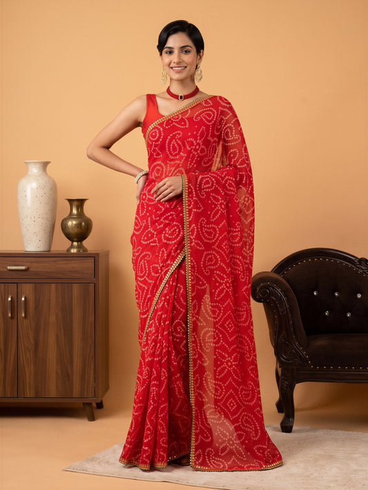 Woman wearing red georgette saree with bandhani tie-dye dot work and red blouse