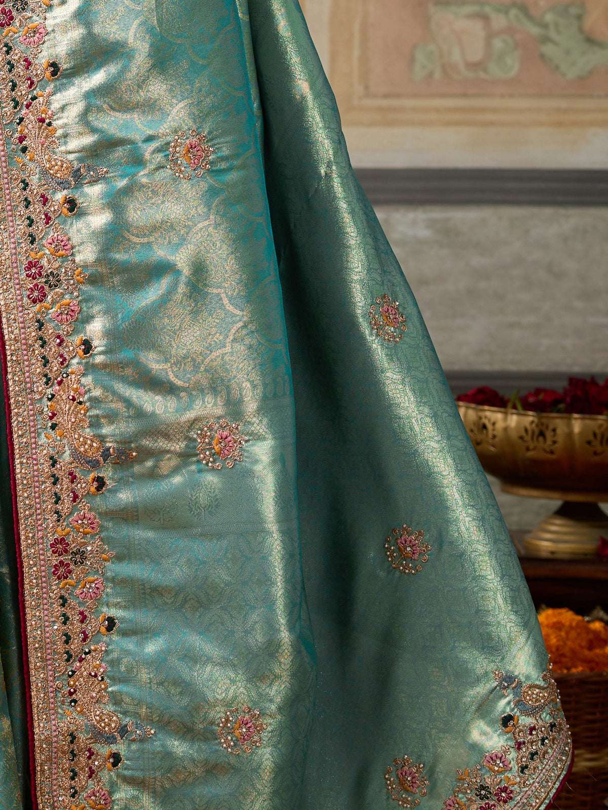 Pallu detail of light blue silk blend saree showing ornamented surface design and embellished border