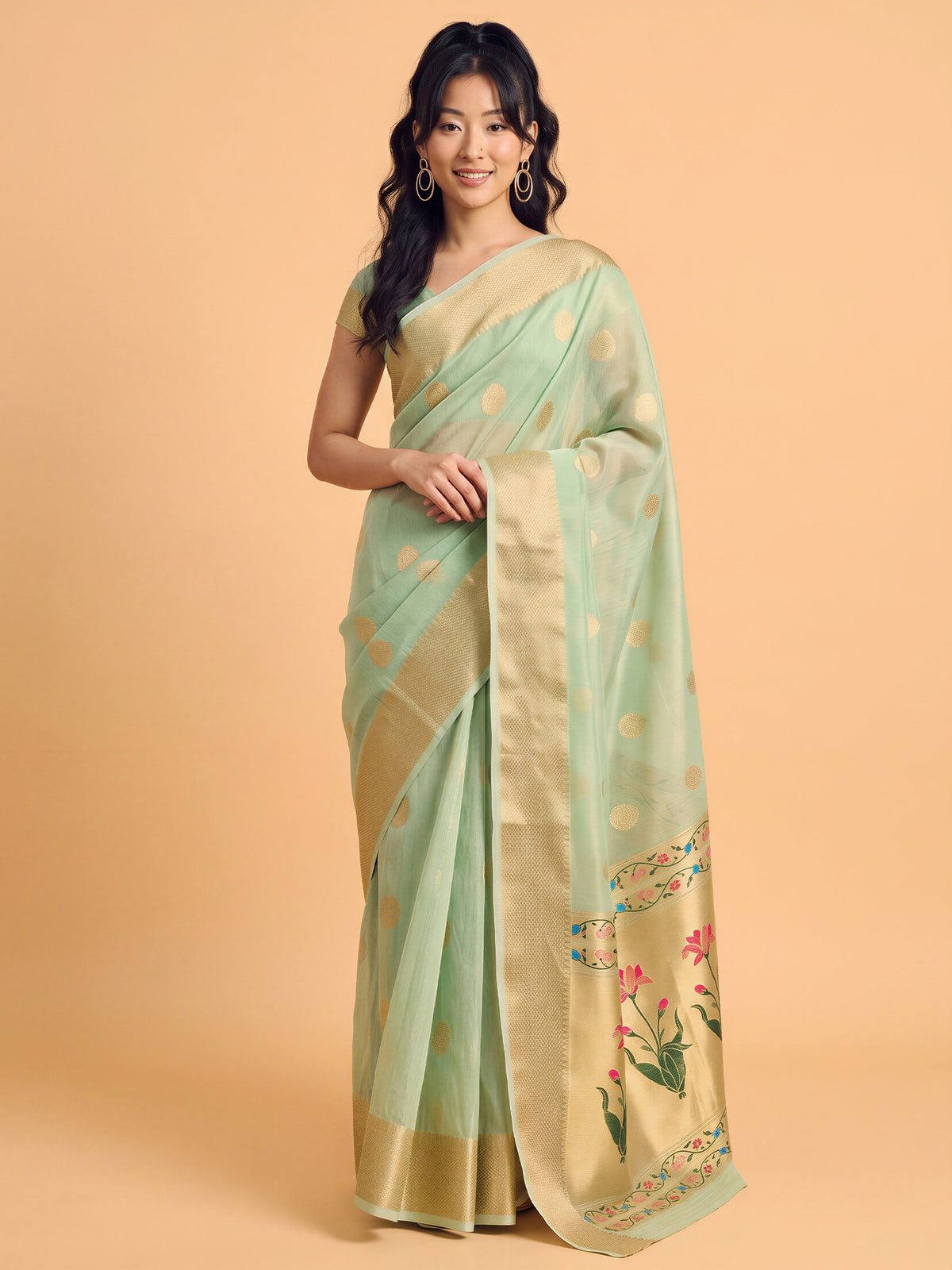 Woman wearing mint green tissue saree with zari butta (metallic motif) work and mint green blouse