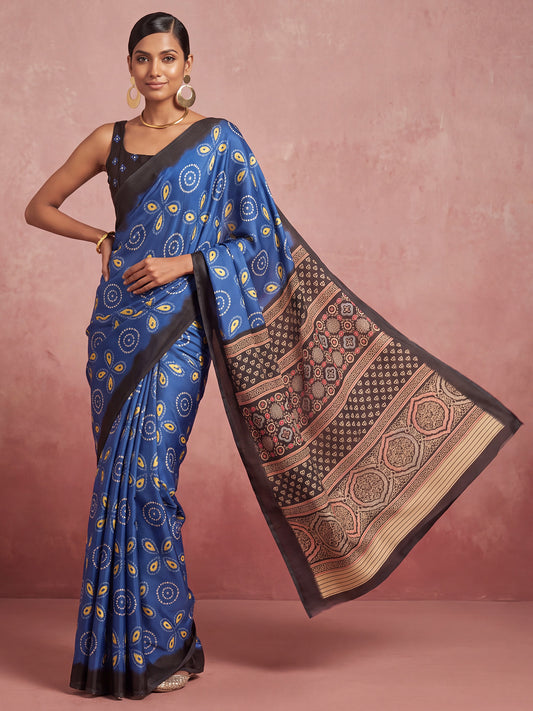 Woman wearing blue satin saree with traditional indian motif work and black blouse