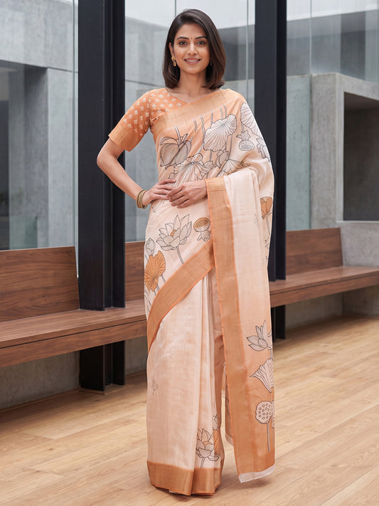 Woman wearing white satin silk saree with traditional indian motif work and peach blouse