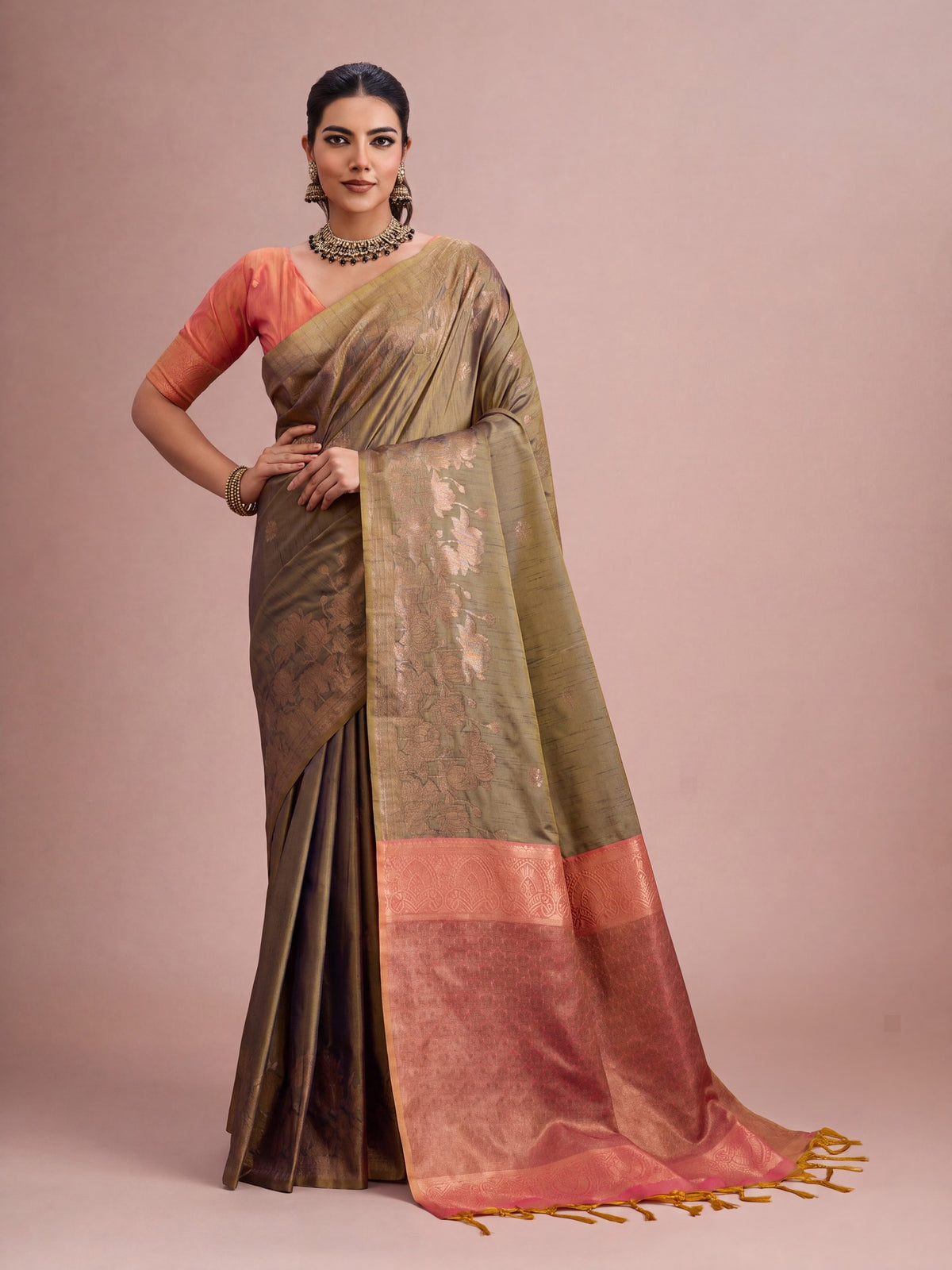 Woman wearing brown tussar silk saree with traditional indian motif work and pink blouse