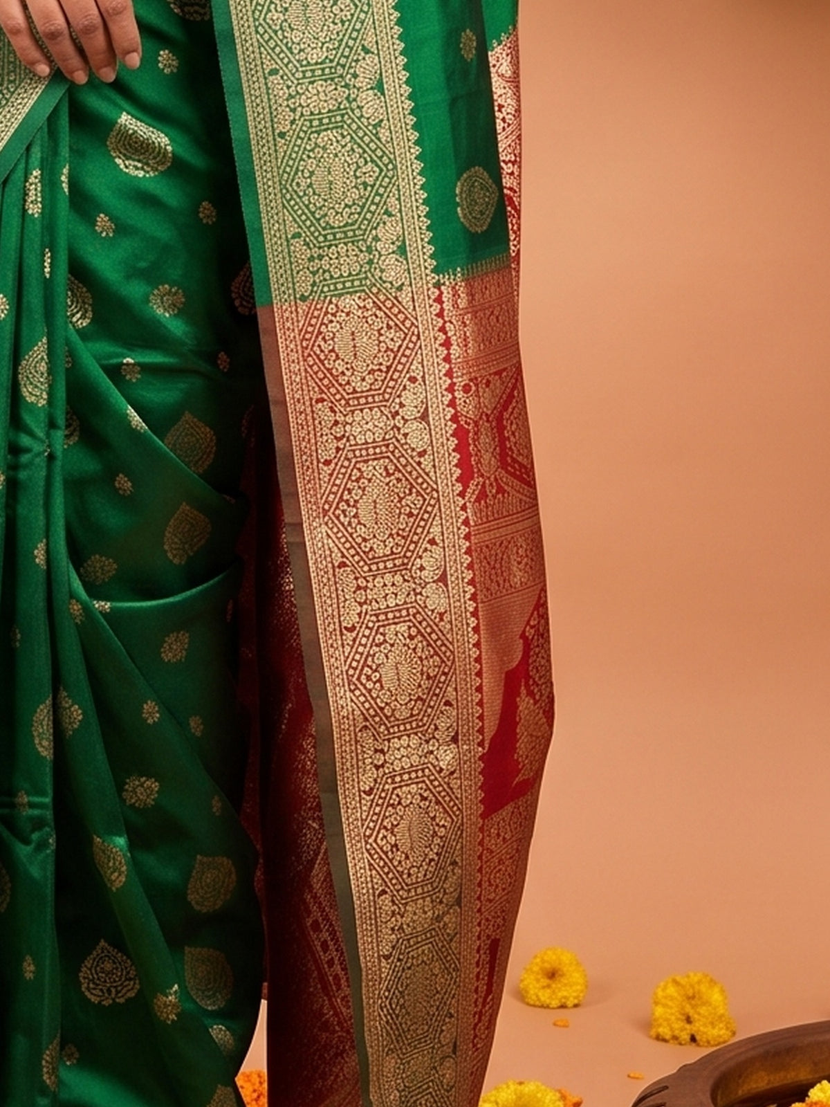 Pallu detail of green silk blend saree showing zari butta (metallic motif) work and zari border