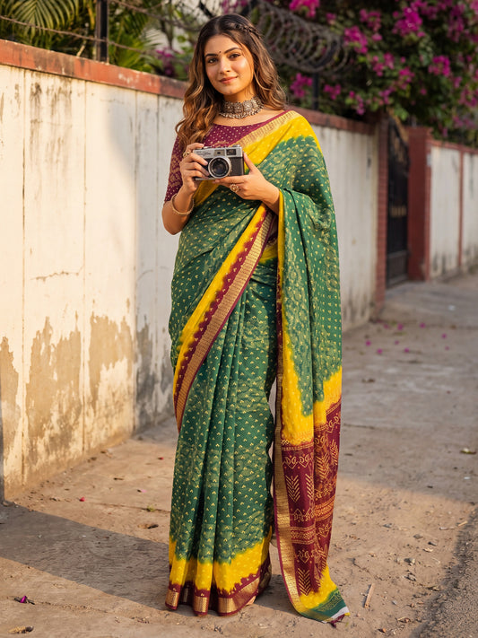 Woman wearing teal green cotton saree with bandhani tie-dye dot work and wine blouse