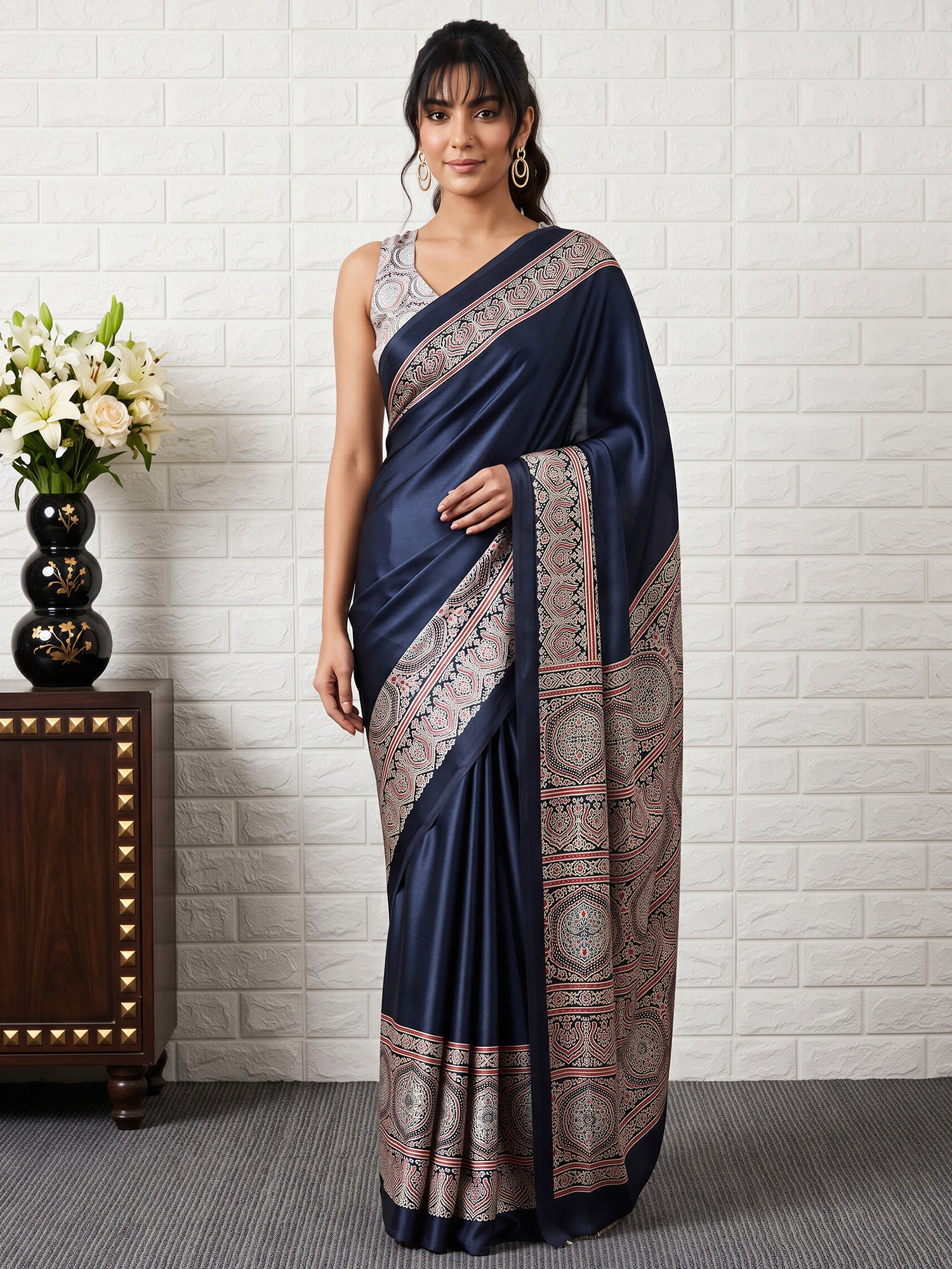 Woman wearing black satin saree with ajrak block-print motif work and black blouse