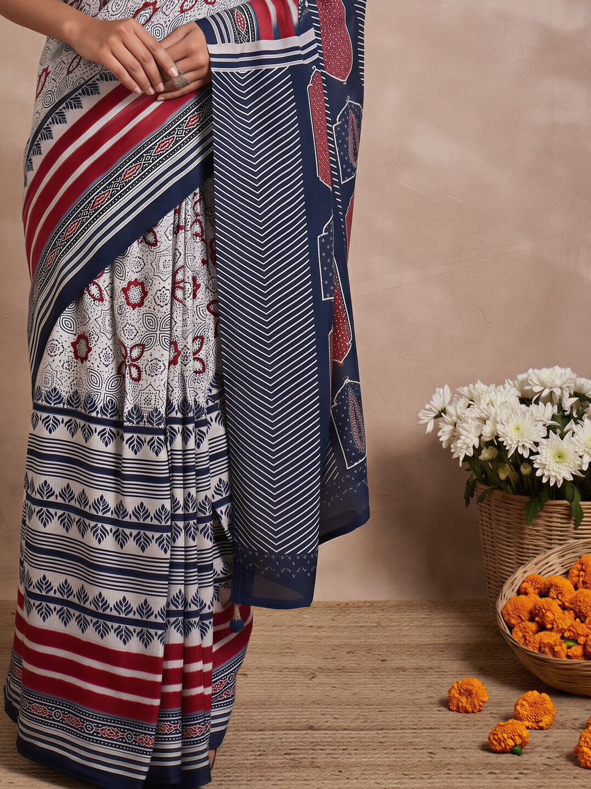 Pallu detail of off white viscose silk saree showing traditional indian motif work and printed border