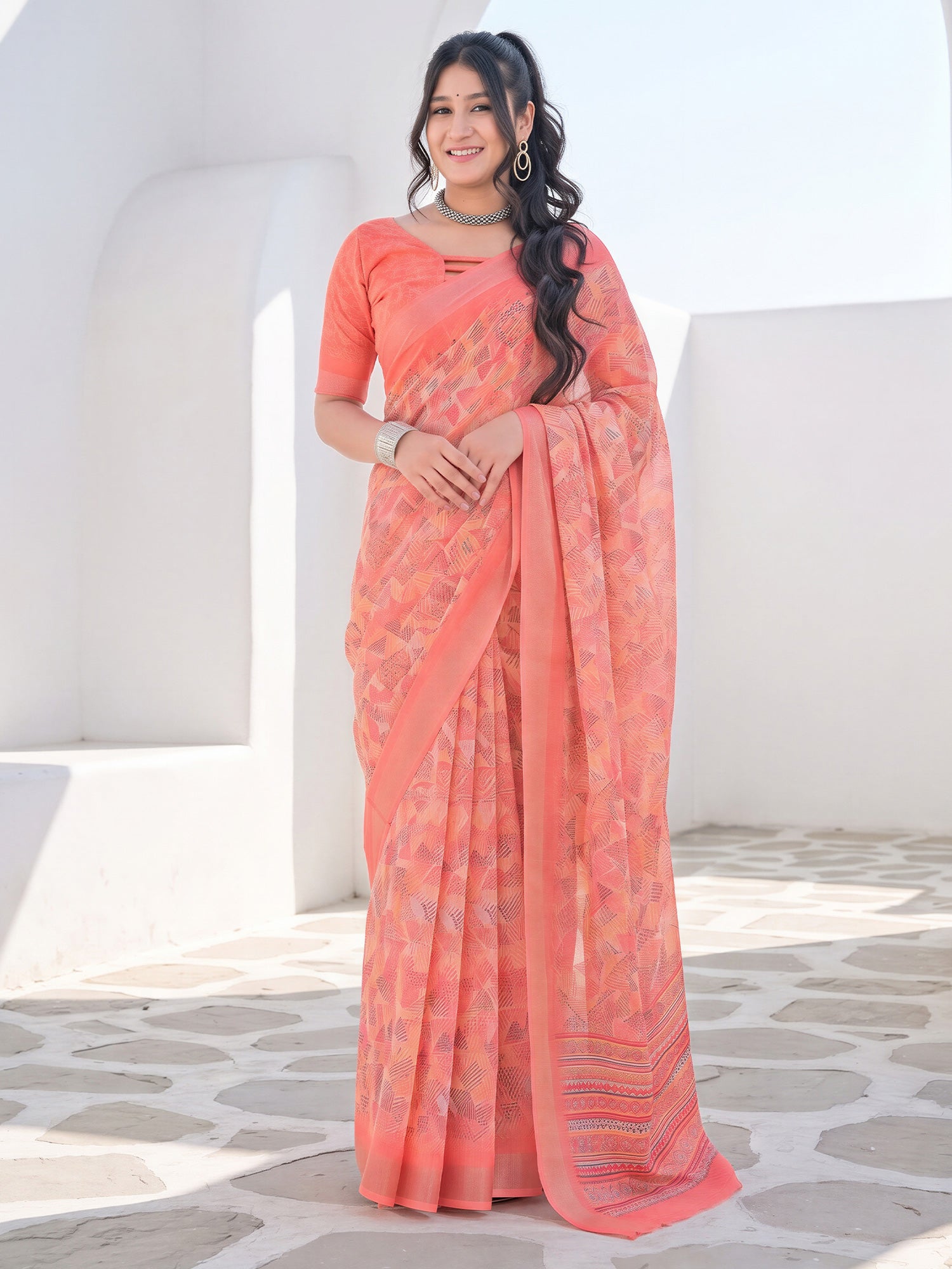 Woman wearing peach cotton linen saree with abstract contemporary design and peach blouse
