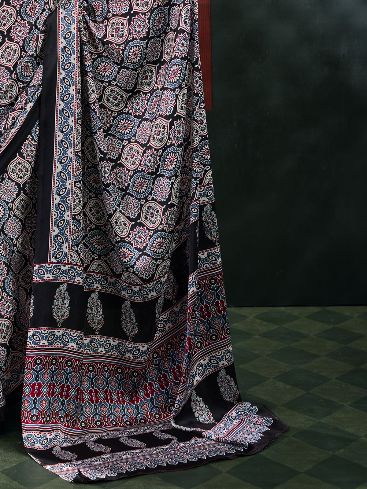 Pallu detail of black satin saree showing ajrak block-print motif work and printed border