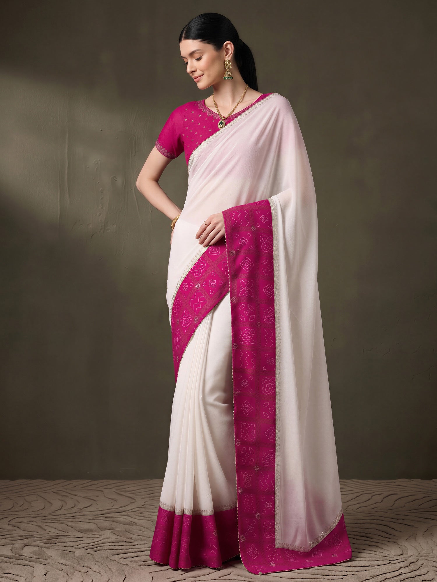 Woman wearing white vichitra silk saree with bandhani tie-dye dot work and pink blouse