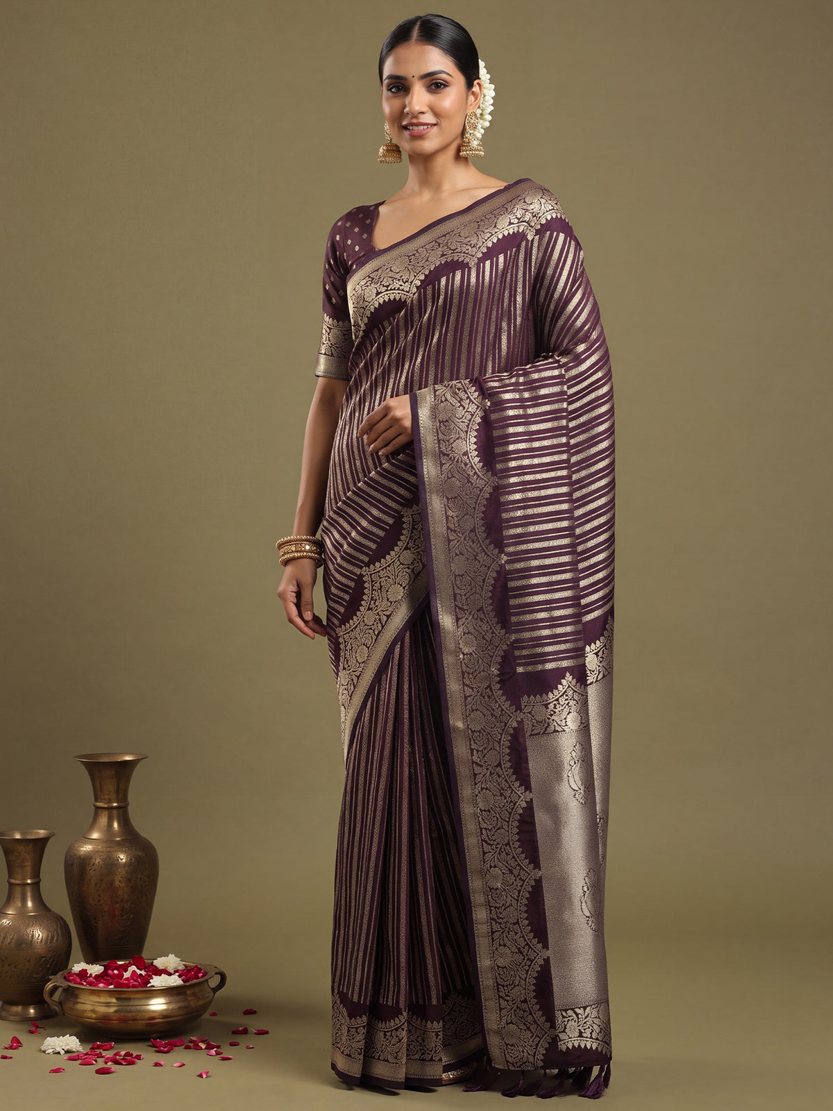 Woman wearing purple georgette saree with striped pattern design and purple blouse