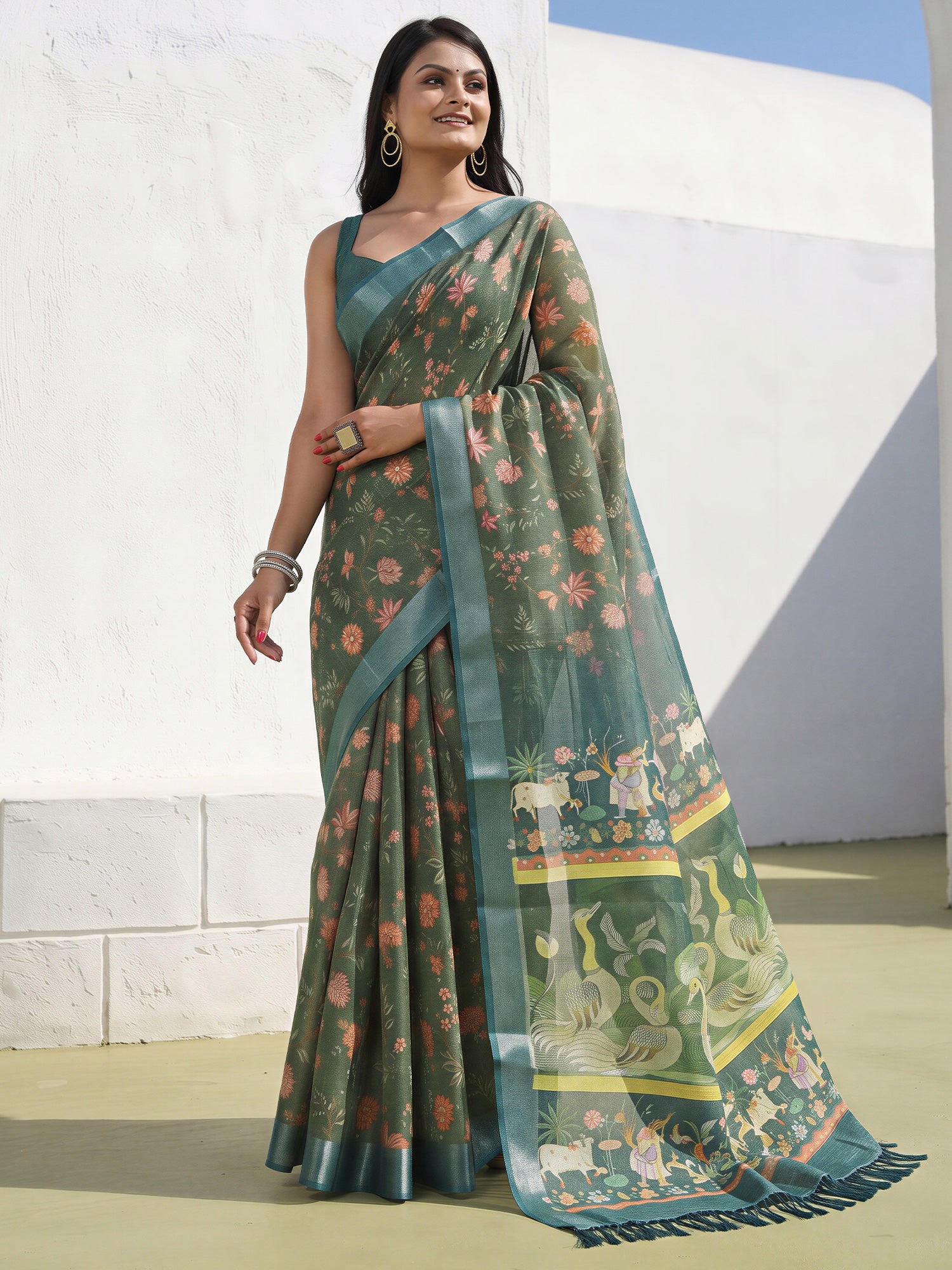 Woman wearing sea green cotton silk saree with traditional indian motif work and sea green blouse