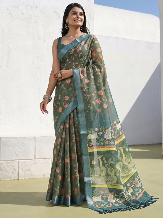 Woman wearing sea green cotton silk saree with traditional indian motif work and sea green blouse
