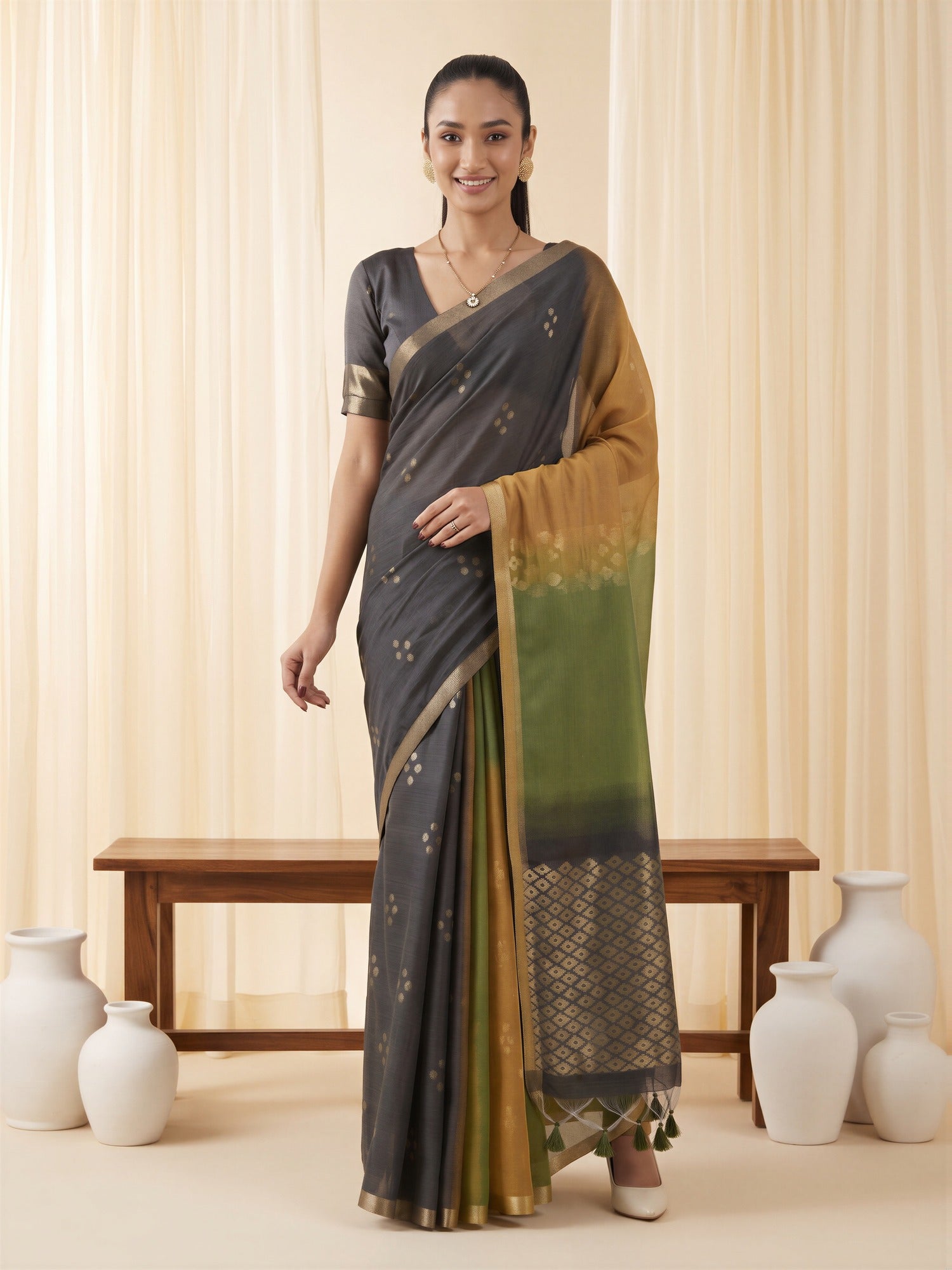Woman wearing mustard viscose silk saree with traditional indian motif work and black blouse