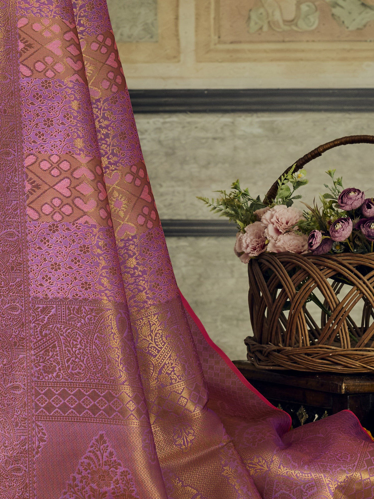 Pallu detail of pink pure silk saree showing woven motif design and zari border