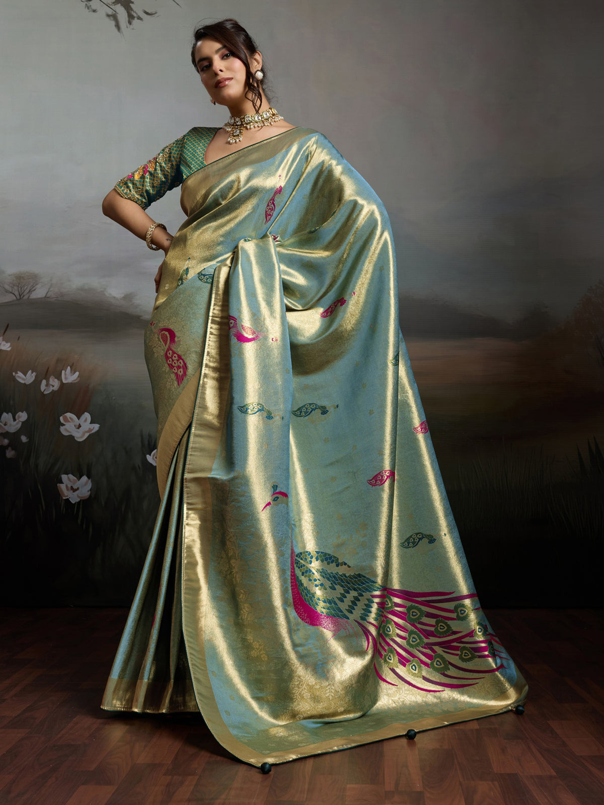 Woman wearing teal green banarasi silk saree with woven motif design and teal green blouse