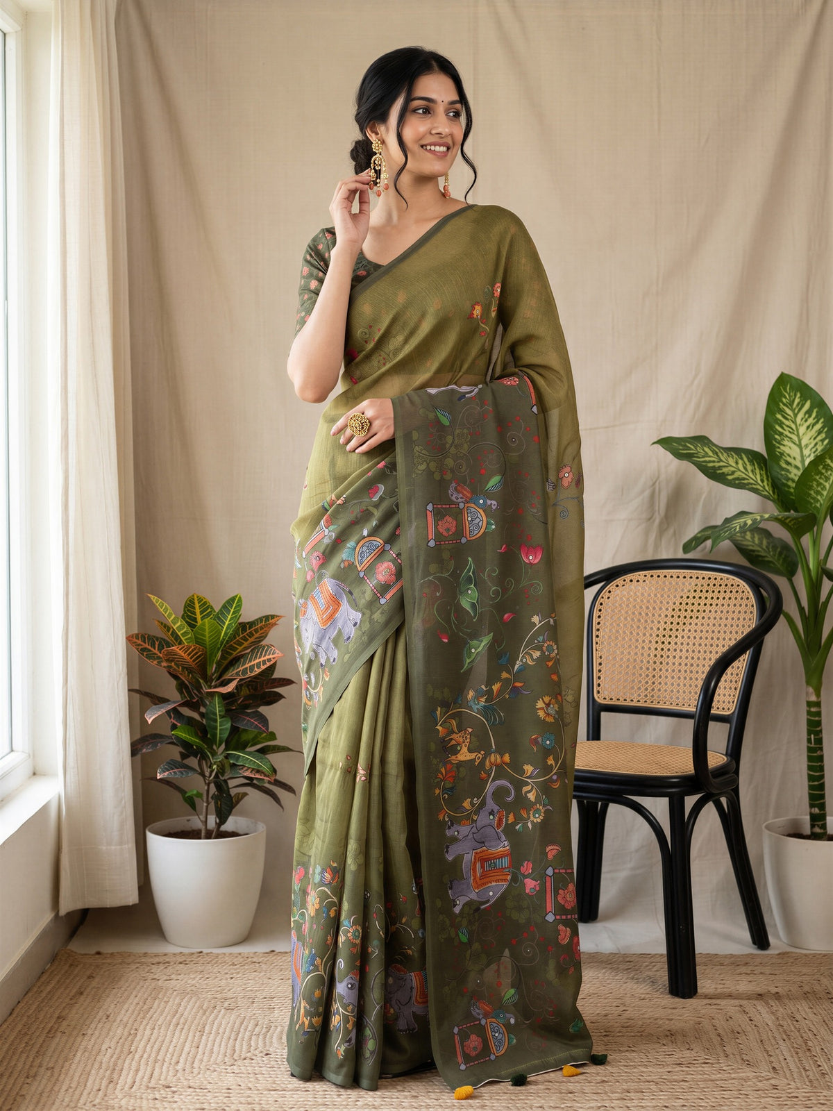 Woman wearing olive linen blend saree with traditional indian motif work and olive blouse