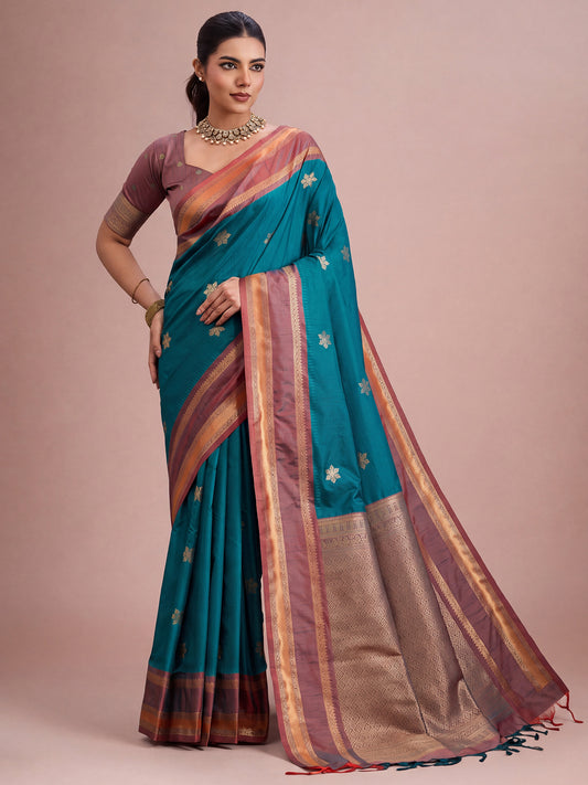 Woman wearing teal blue tussar silk saree with traditional indian motif work and mauve blouse
