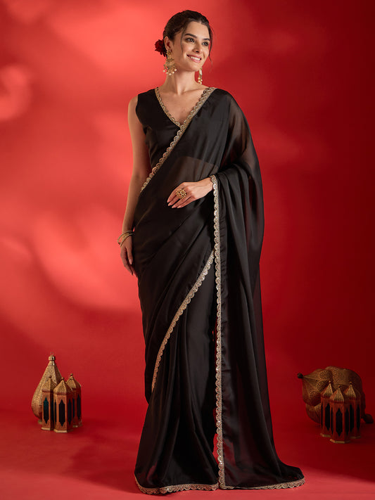Woman wearing black pure georgette saree with clean solid-tone finish and black blouse
