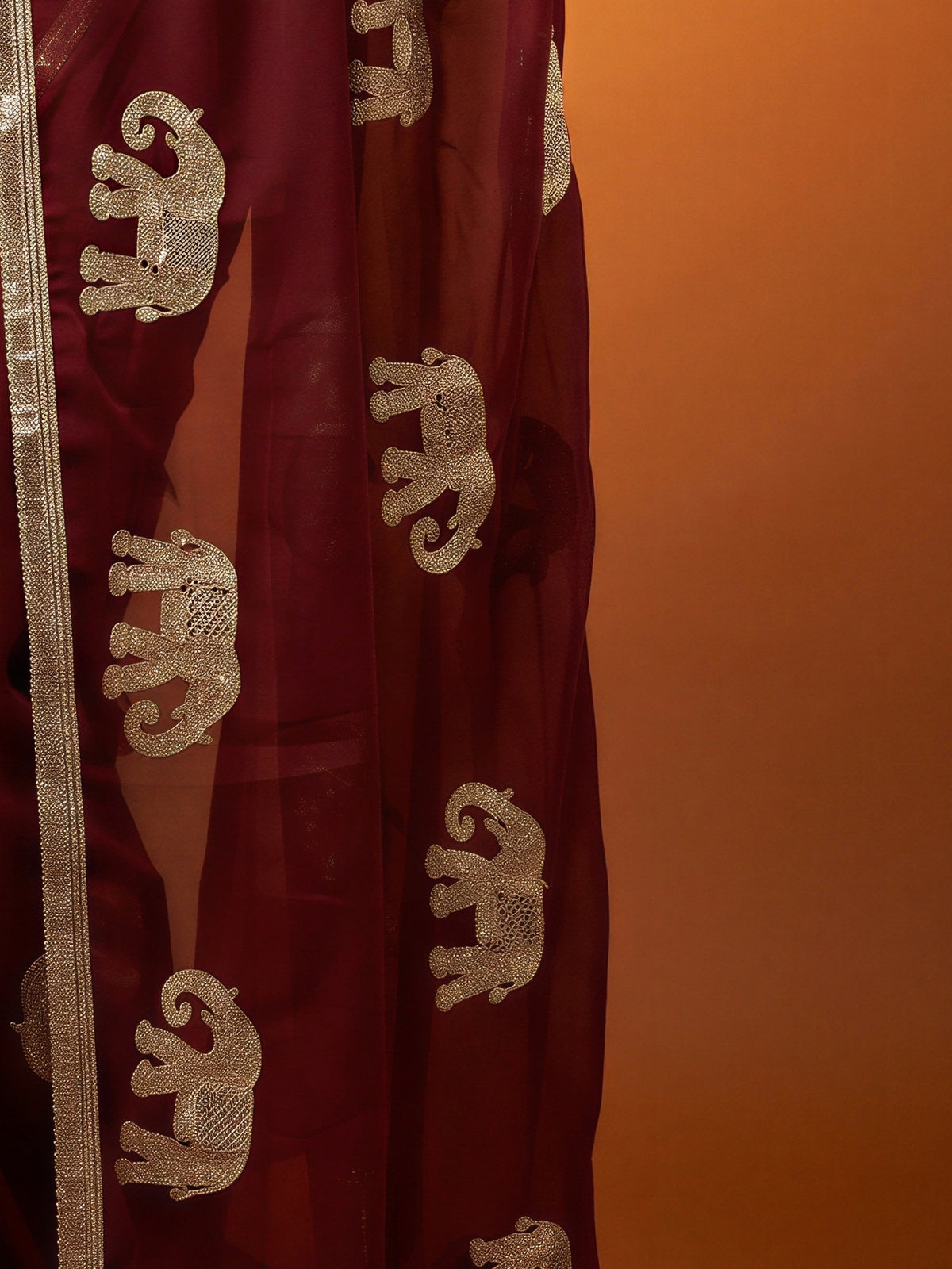 Pallu detail of maroon georgette saree showing embroidered motif work and embellished border
