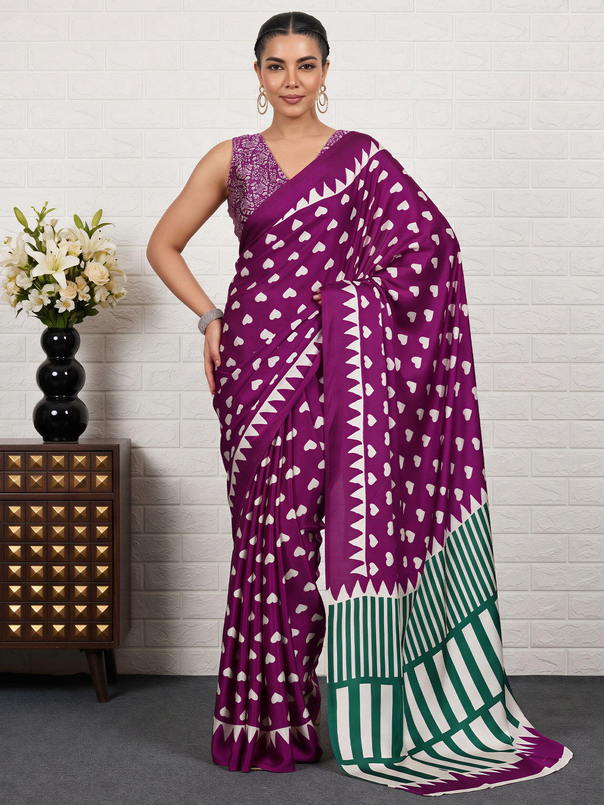 Woman wearing purple satin saree with traditional indian motif work and purple blouse