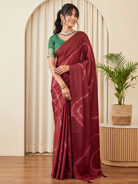 Woman wearing burgundy satin silk saree with tie-and-dye resist pattern and burgundy blouse
