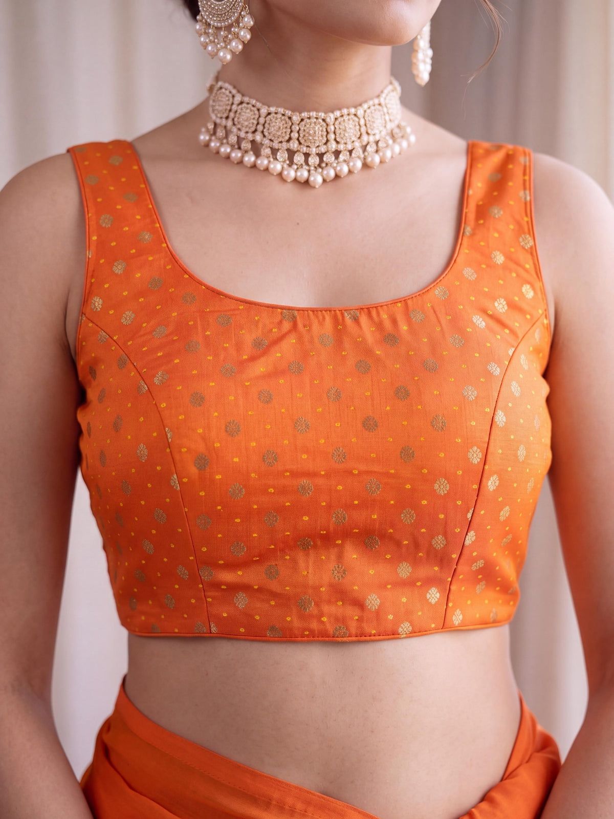 Orange zari woven silk blend sleeveless readymade saree blouse with round neck view 1