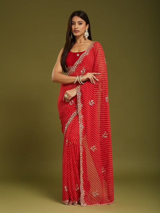Woman wearing red georgette saree with leheriya diagonal wave stripes and red blouse