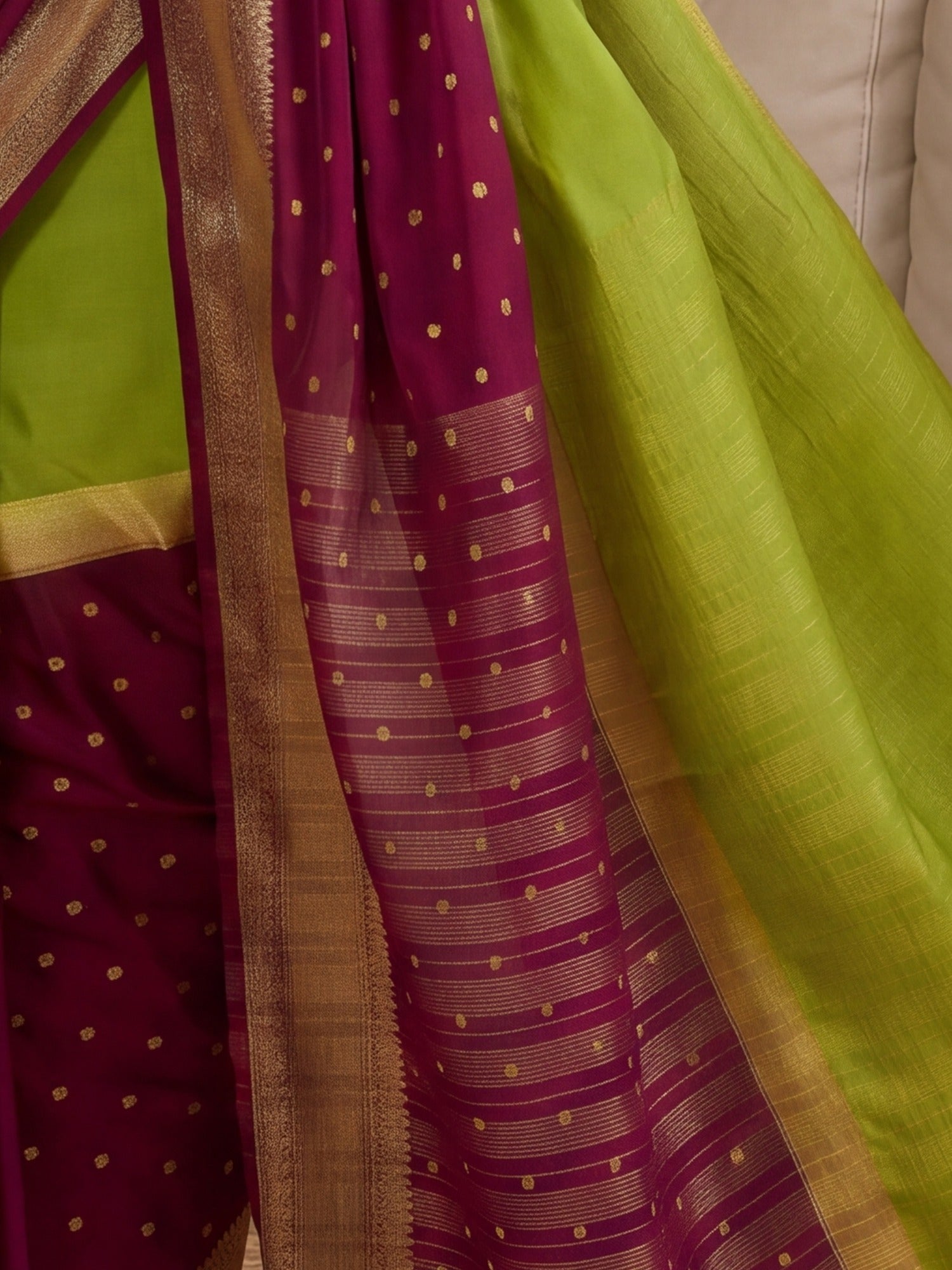 Pallu detail of light green mysore silk saree showing zari butta (metallic motif) work and zari border