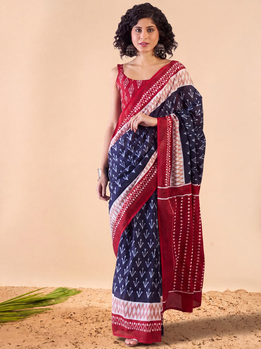 Woman wearing navy blue cotton saree with ikat resist-dyed pattern and red blouse