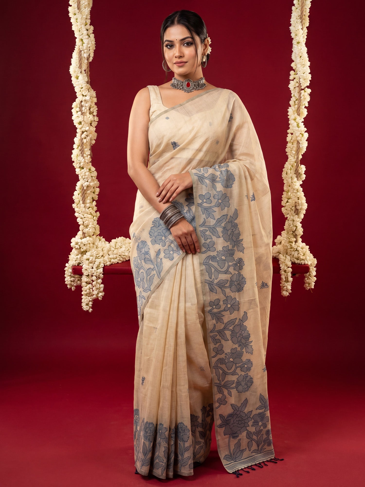 Woman wearing cream chanderi cotton saree with all-over floral design and cream blouse