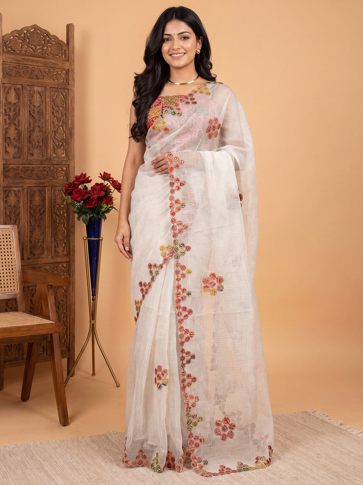 Woman wearing white kota doria cotton saree with traditional indian motif work and multicolored blouse