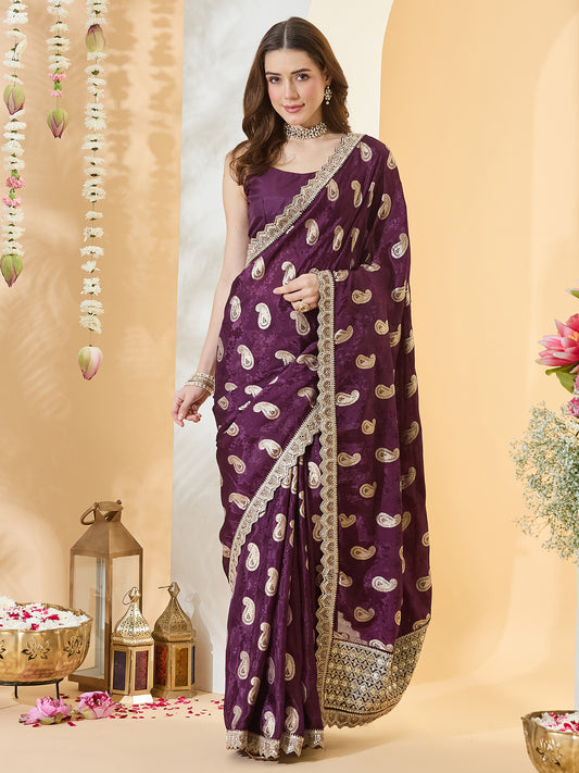 Woman wearing purple viscose silk saree with zari butta (metallic motif) work and purple blouse